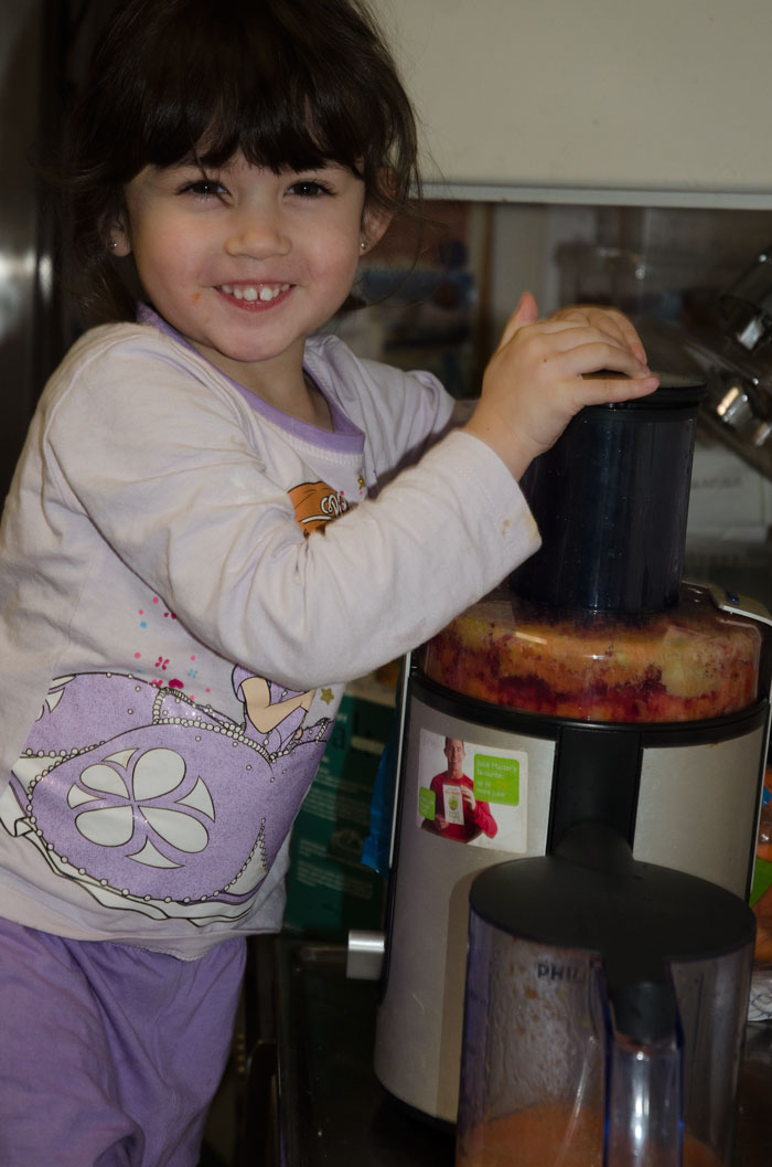 Isabelle hygger sig med juiceproduktionen - man kan godt blive lidt beskidt i køkkenet :-)